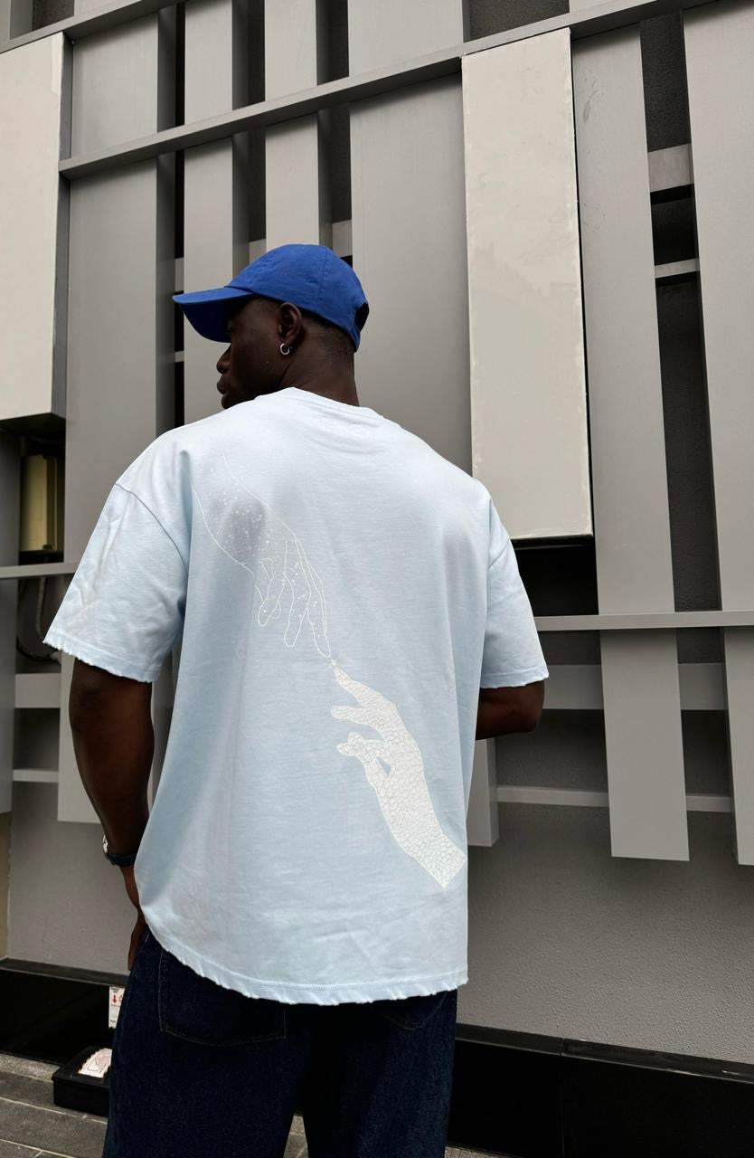 Model wearing the baby blue Past x Future tee, back print